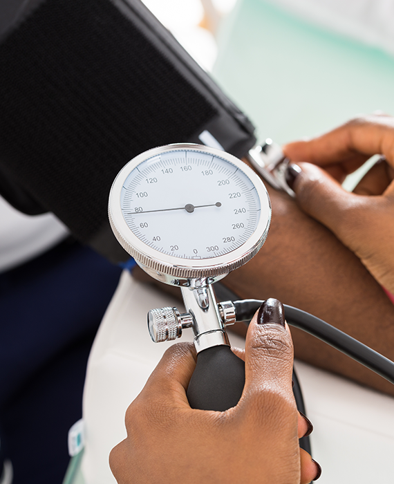 Close up on a blood pressure cuff on a woman's arm