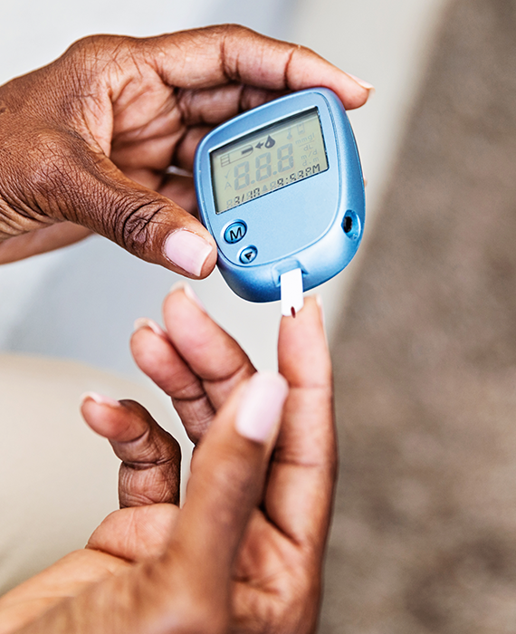 Young Black woman with insulin arm monitor